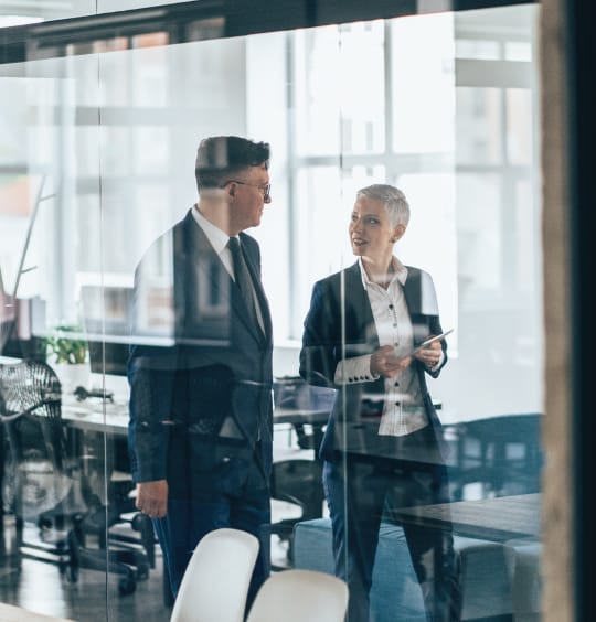 employees talking while exiting a conference room